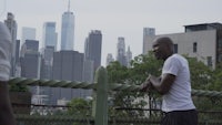 a man is playing a game of frisbee on a fence