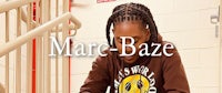 marc-baze - a young man with dreadlocks writing on a piece of paper